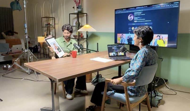 A guest holding up a photo during a podcast taping